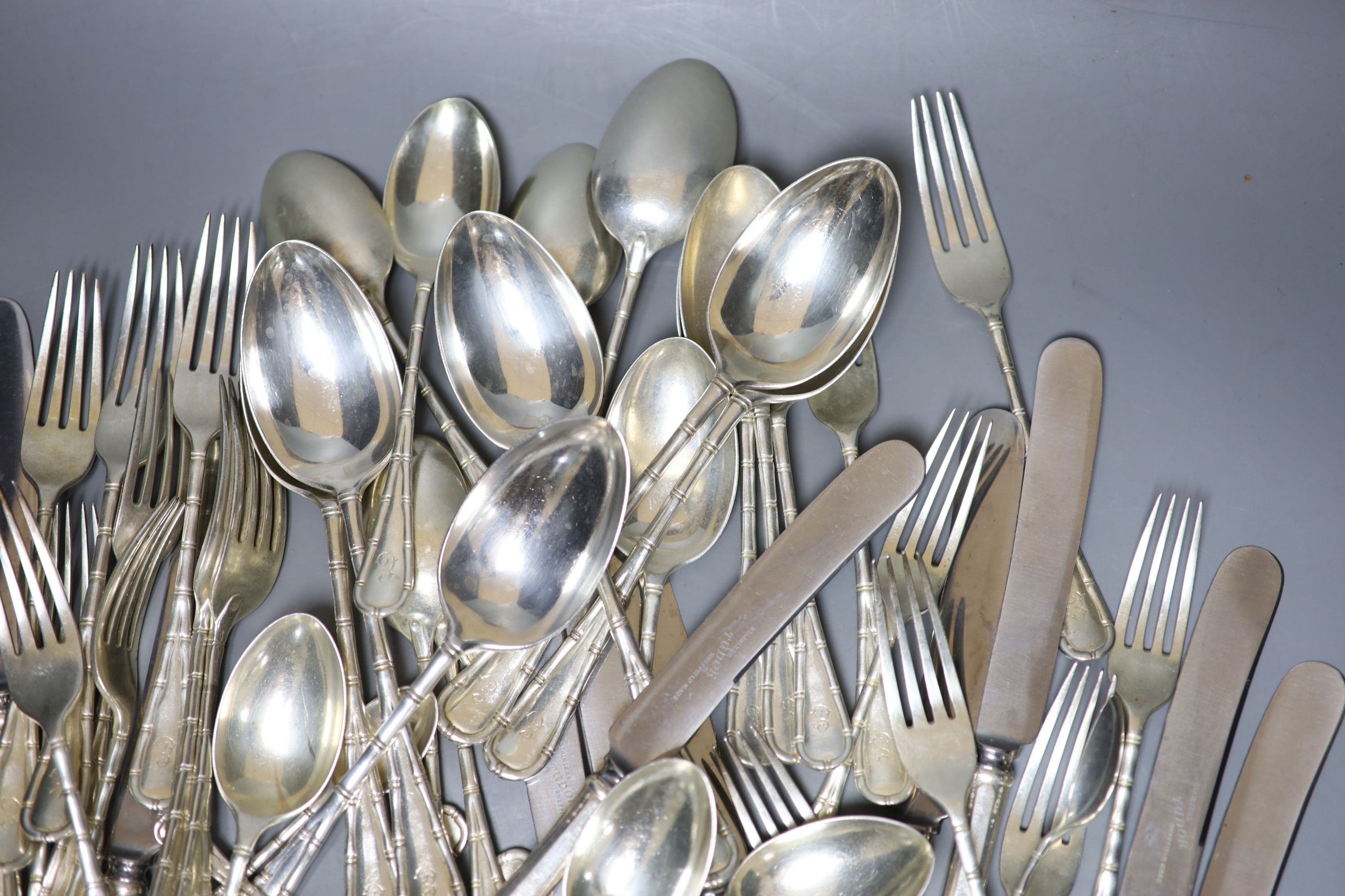 A part canteen of Edwardian silver cutlery by Atkin Brothers, Sheffield, 1903, with engraved initial, comprising forty nine items, 108oz, together with twelve later associated silver plated handled steel table knives.